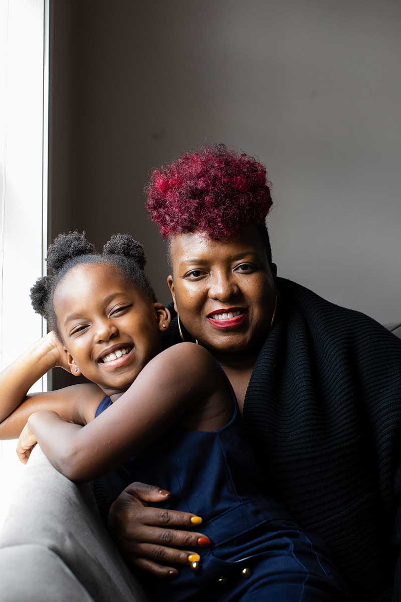 african american smiling mom and daughter